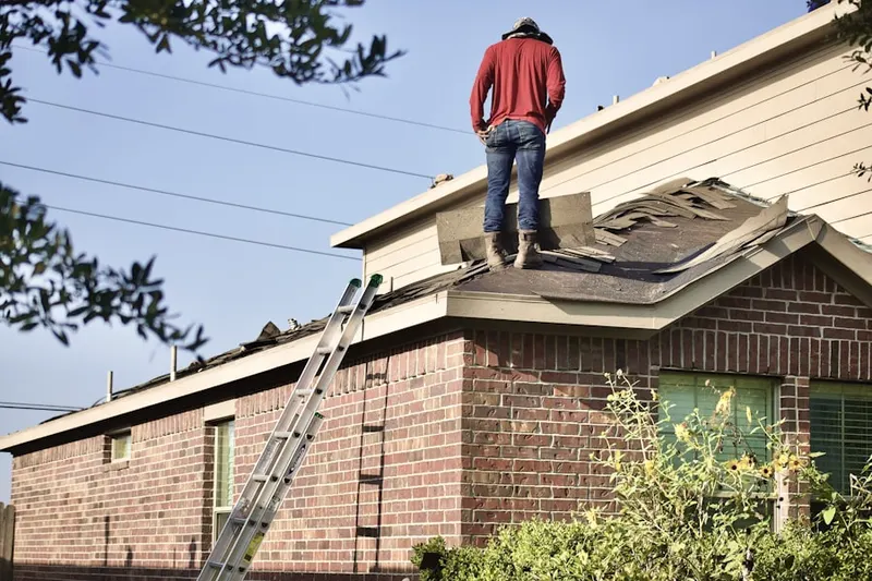 Professional roofer working on a residential roof in Galveston
